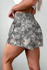 Floral patterned skirt worn by a person on a plain background