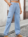 Person wearing light blue cargo jeans on a street background