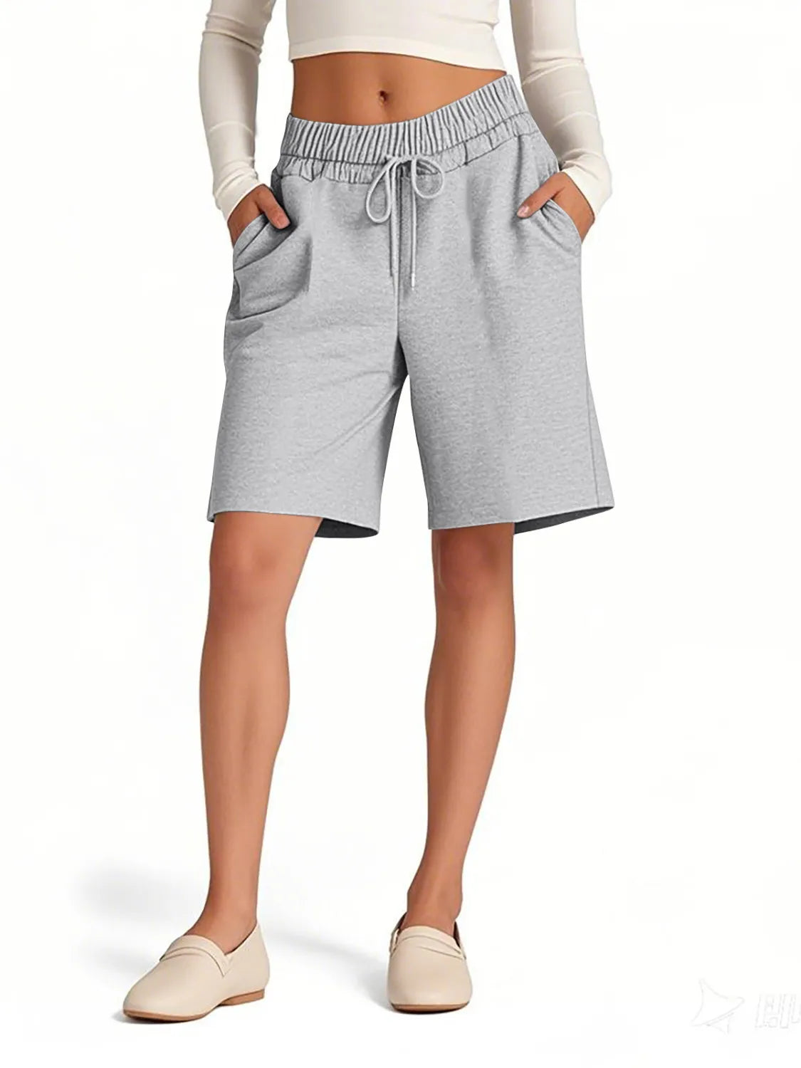 Person wearing gray shorts on a white background