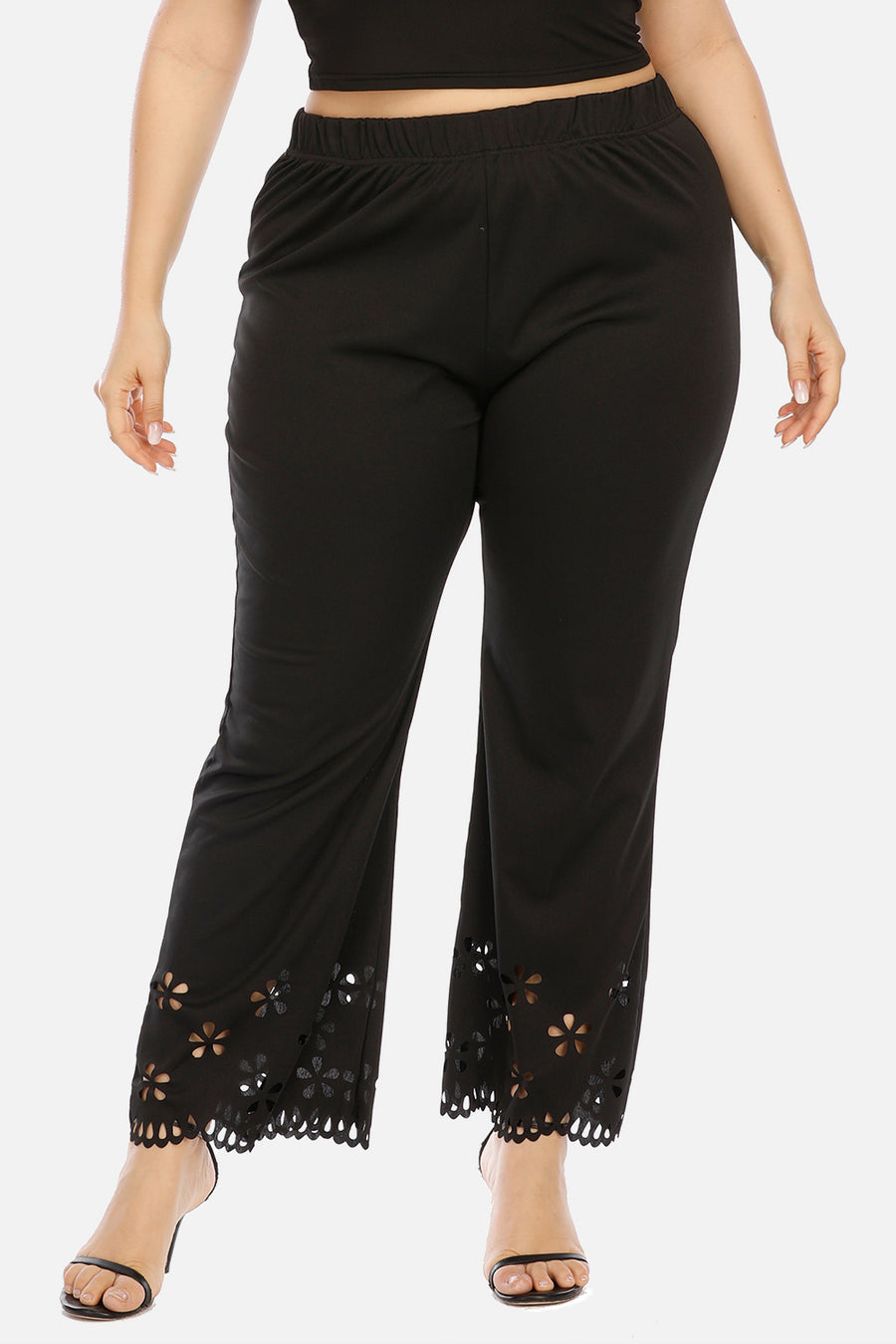 Black pants with lace detailing on a white background