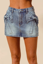 Denim skirt with bow details on a beige background
