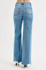 Light blue flared jeans on a white background