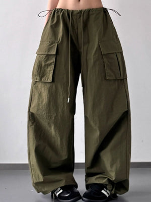 Green cargo pants worn by a person on a plain background
