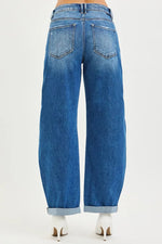 Back side view of of a lady wearing Blue jeans on a white background