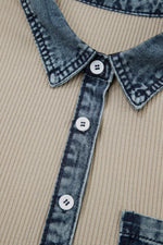 Close-up of a shirt with denim collar and buttons on a beige background