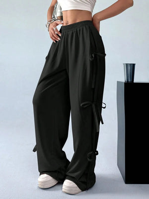 Black wide-leg pants worn by a person on a light gray background