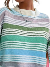 Close-up of a person wearing a colorful striped sweater with a necklace.