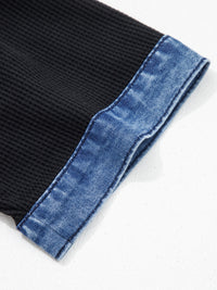 Black fabric with blue denim edge on a white background