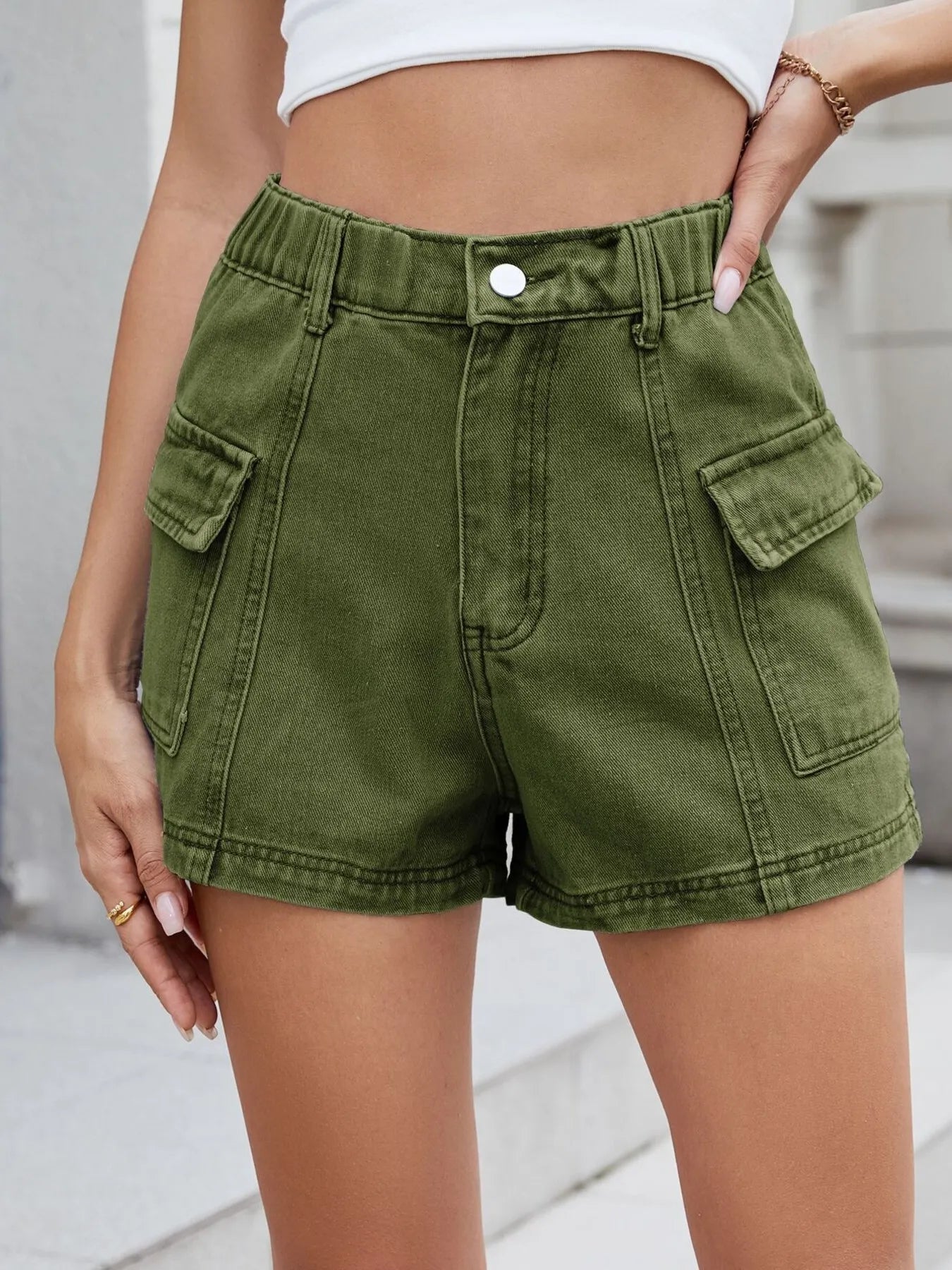 Green shorts worn by a person with a blurred background