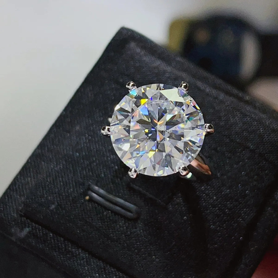 Diamond ring on a black cushion with a blurred background
