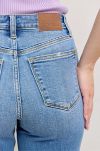 Close-up of blue jeans with a Judy Blue label on a light background