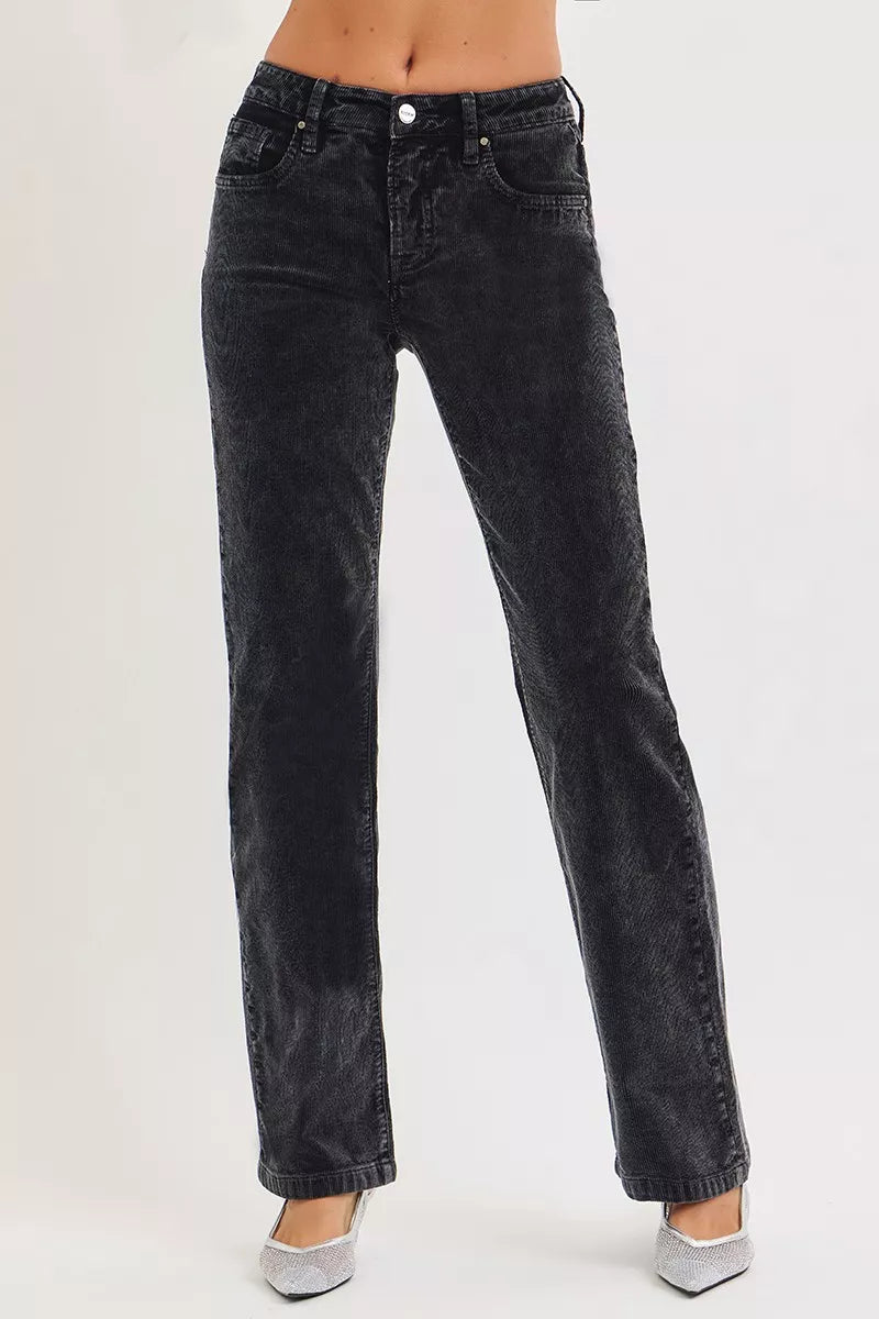 Black jeans worn by a person on a white background