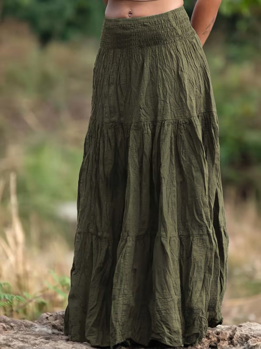 Green tiered skirt worn by a person in a natural setting
