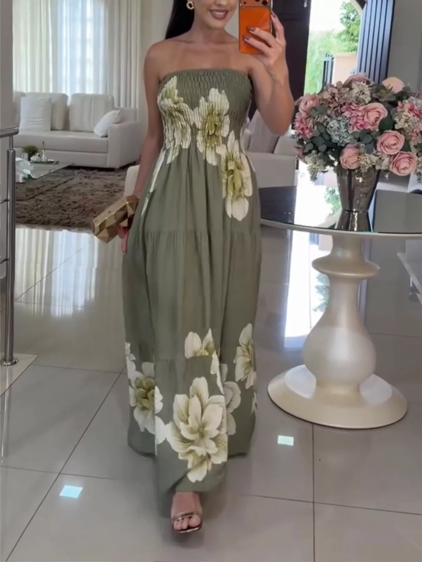 Woman wearing a floral dress in a living room setting