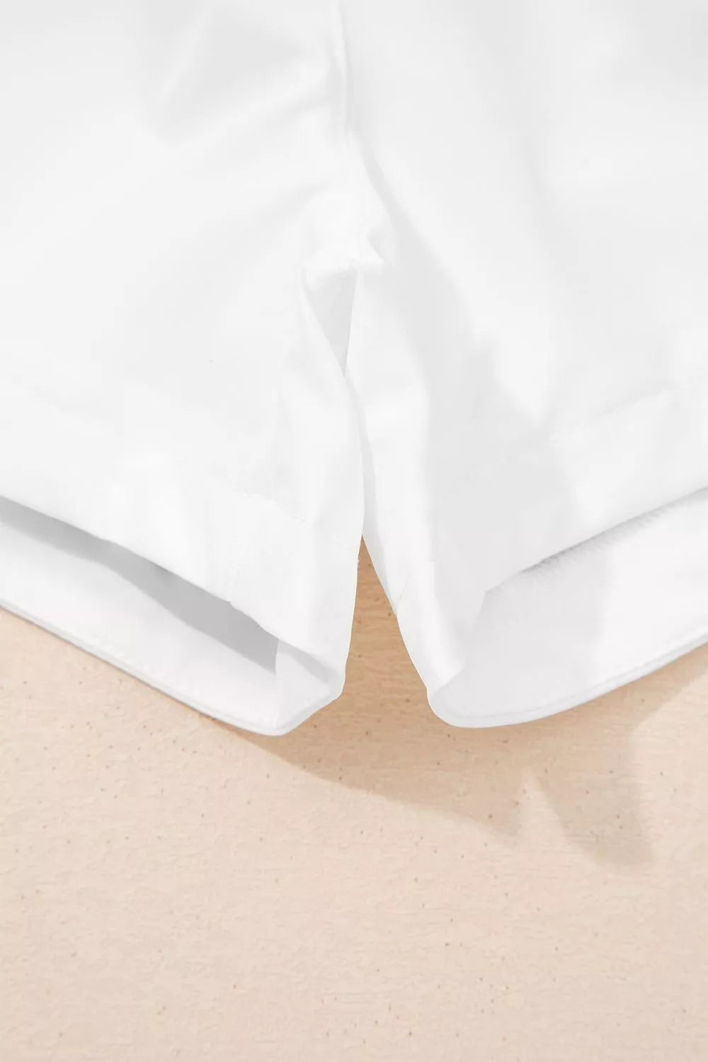 Close-up of white fabric on a beige surface