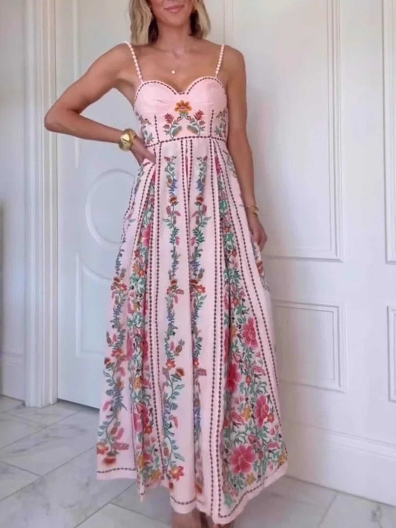 Woman wearing a floral dress with a white door in the background