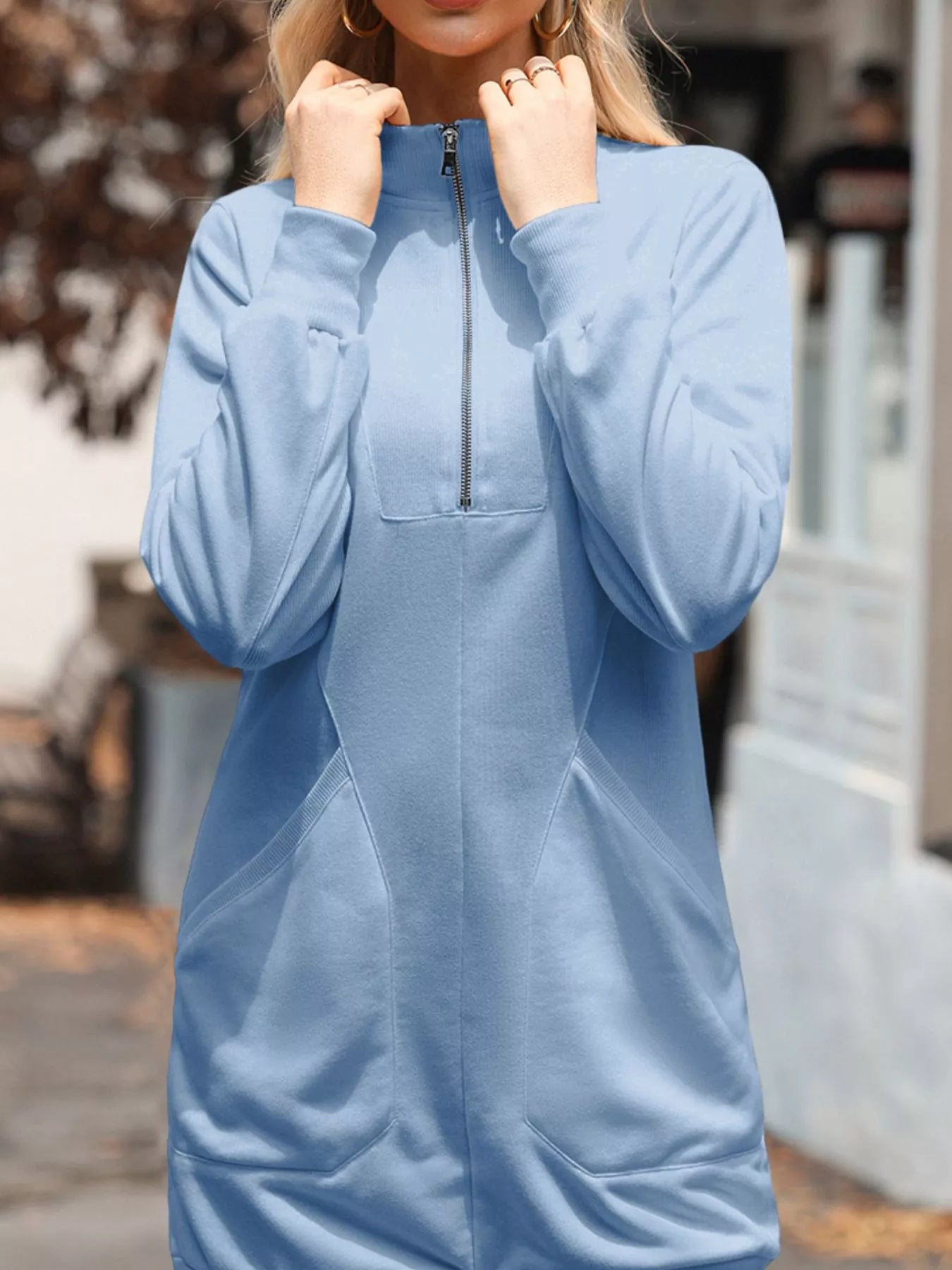 Light blue dress with a zipper detail worn by a person outdoors.