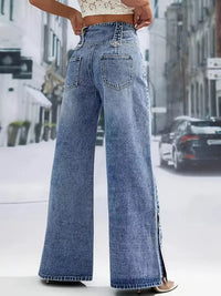 Person wearing high-waisted blue jeans on a city street background