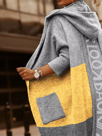 Person wearing a gray and yellow jacket with a blurred background