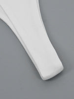 White plastic spatula on a gray background