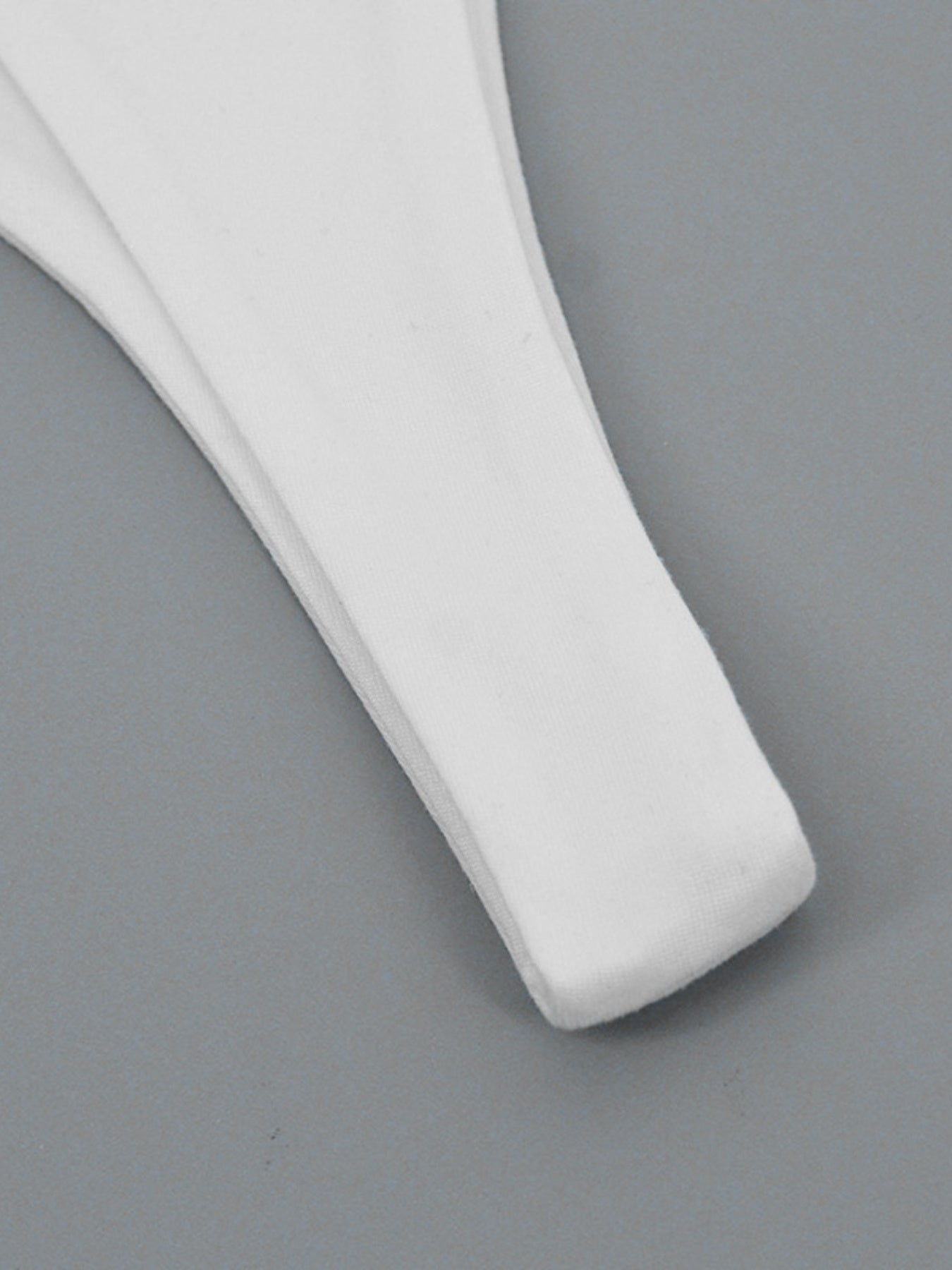 White plastic spatula on a gray background
