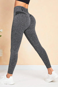 Gray leggings with a brand logo on a beige background