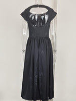 Black dress with sheer panels on a white background