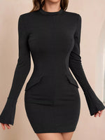 Black long-sleeve dress with flared cuffs on a beige background