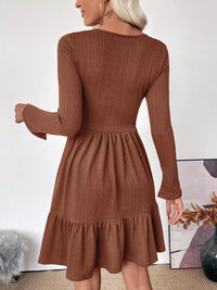 Brown ribbed dress with long sleeves and a ruffled skirt worn by a person.