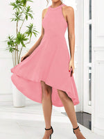 Pink dress worn by a person in a minimal indoor setting with a plant.