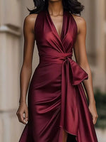 Maroon satin dress worn by a model with a blurred background