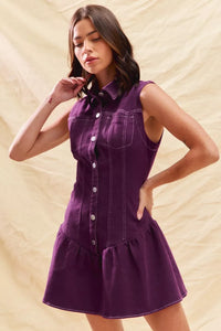 Woman wearing a purple dress against a beige background