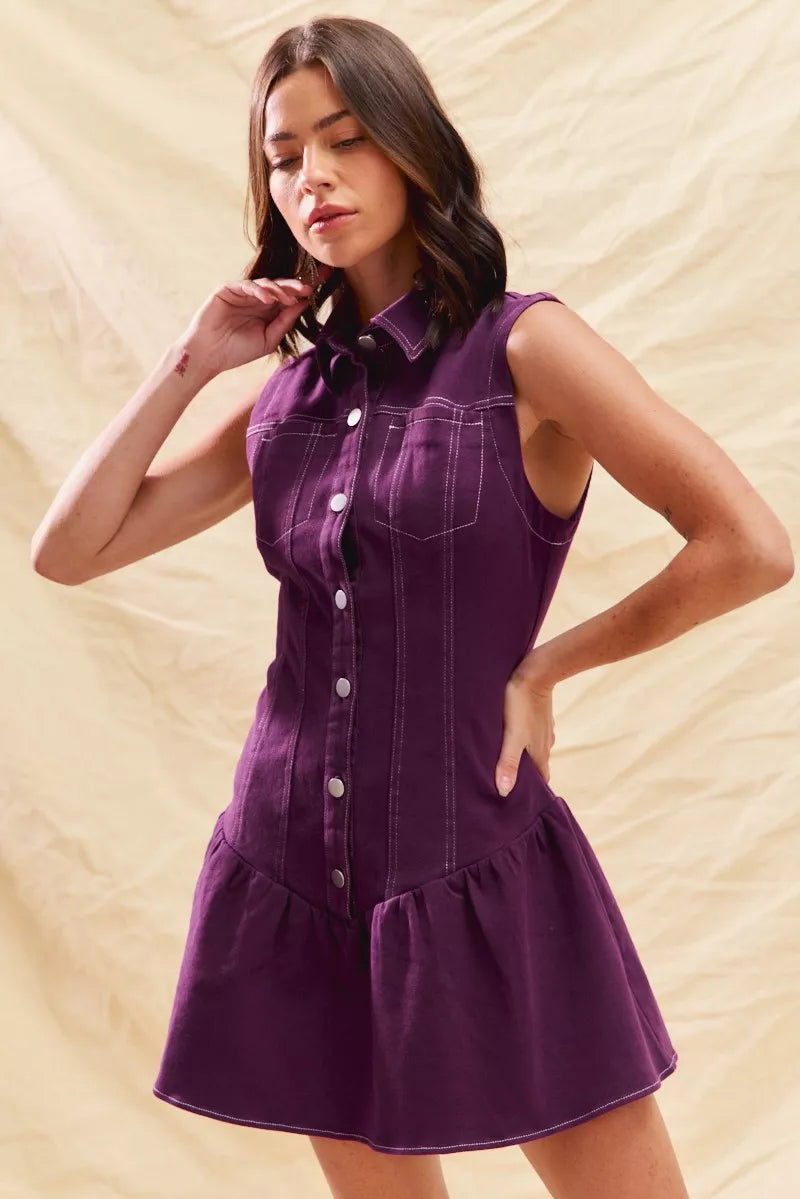 Woman wearing a purple dress against a beige background