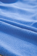 Close-up of blue fabric with visible texture