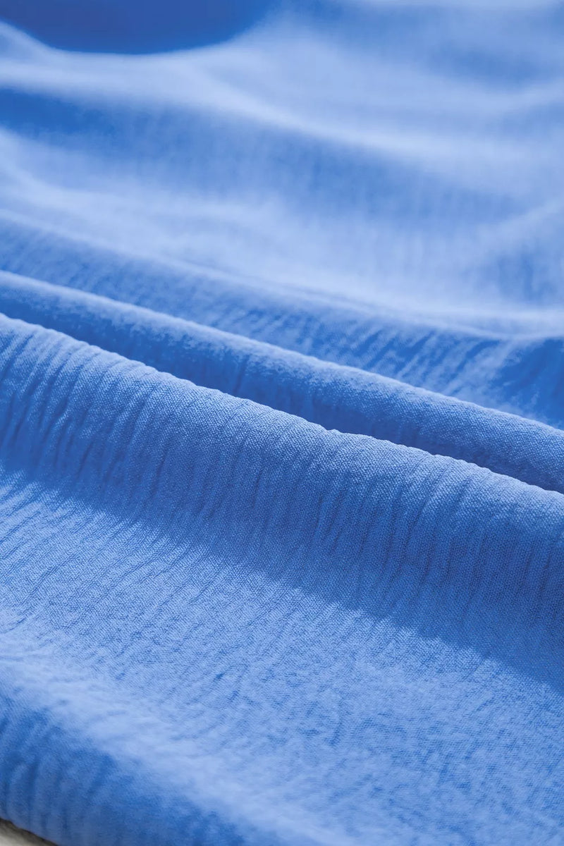 Close-up of blue fabric with visible texture