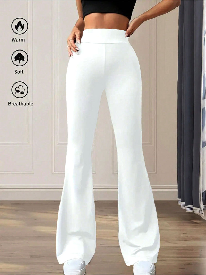 White wide-leg pants worn by a person in a room with neutral decor.