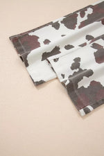 Two cow print napkins on a beige background