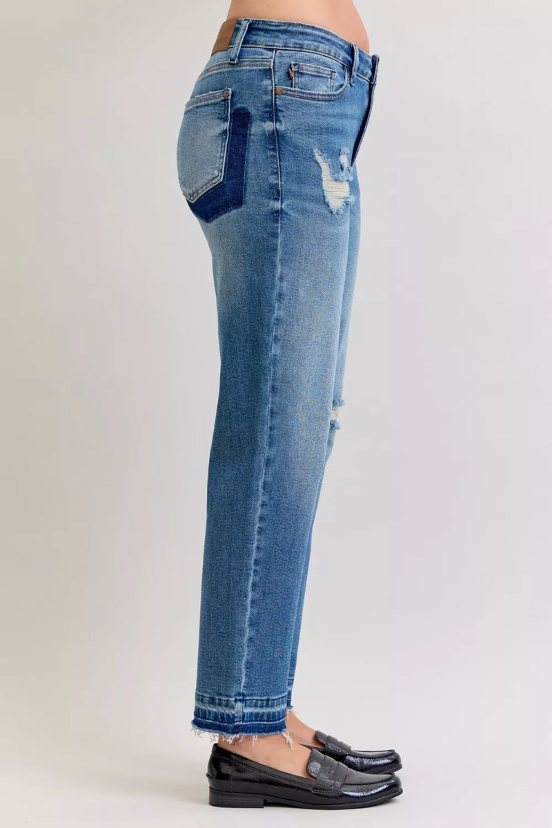 Blue jeans with patchwork design on a white background