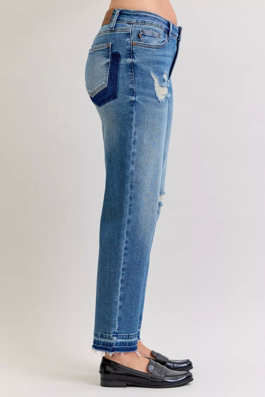 Blue jeans with patchwork design on a white background