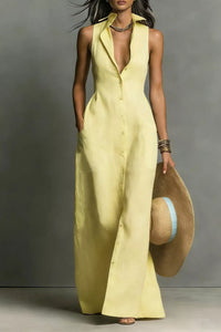 Woman wearing a long yellow dress holding a straw hat against a gray background