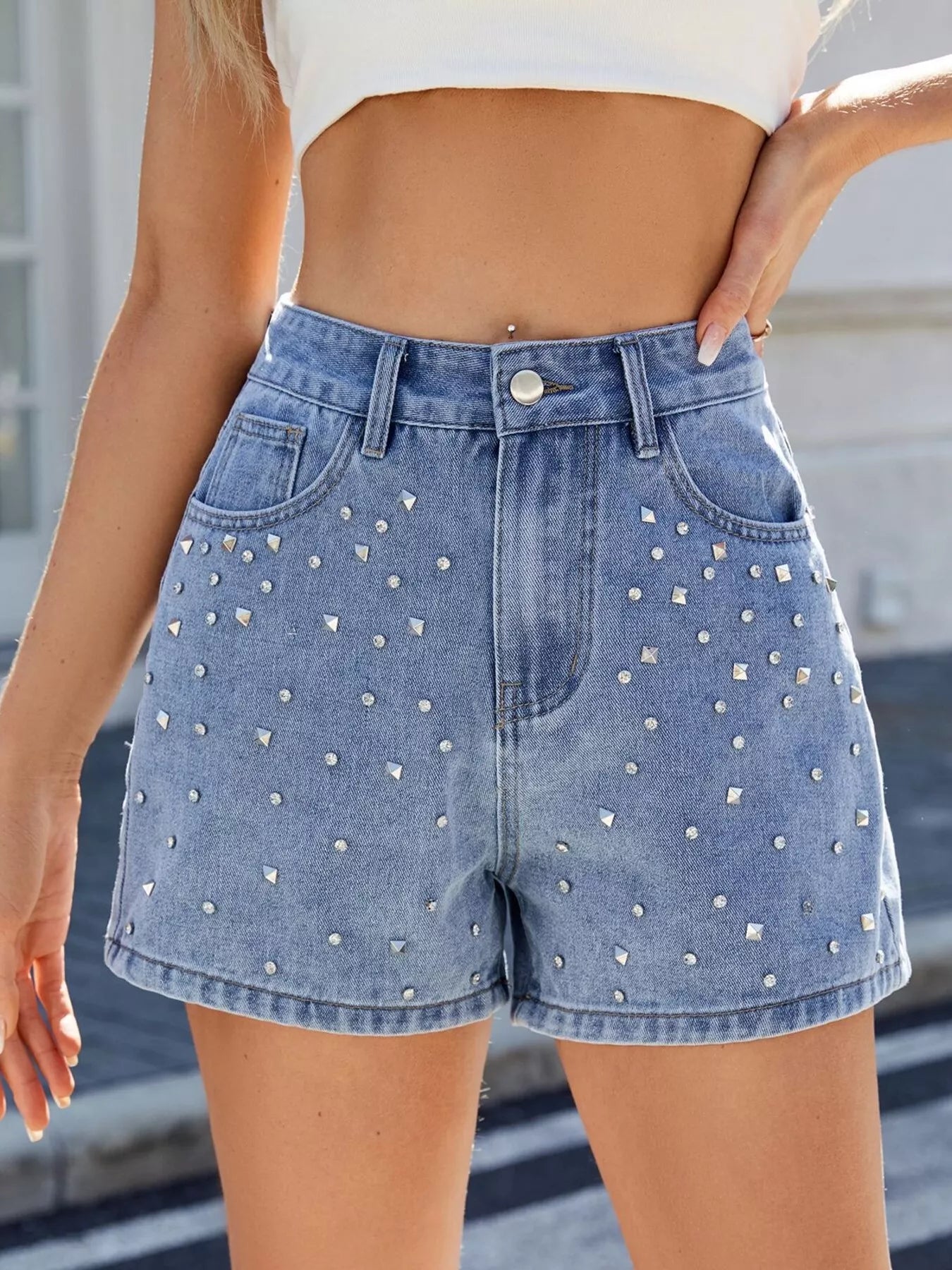 Denim shorts with rhinestone embellishments worn by a person.