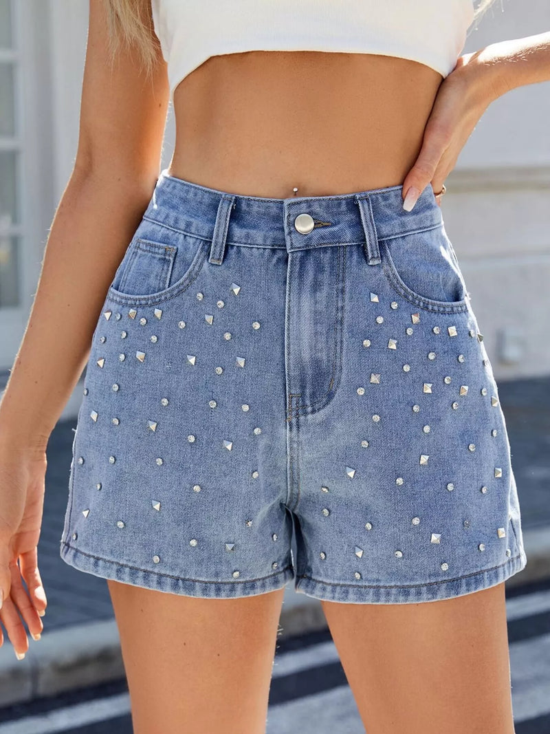 Denim shorts with rhinestone embellishments worn by a person.