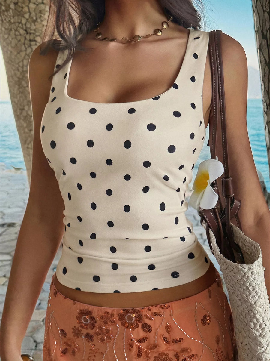 Woman wearing a polka dot top with a beach background