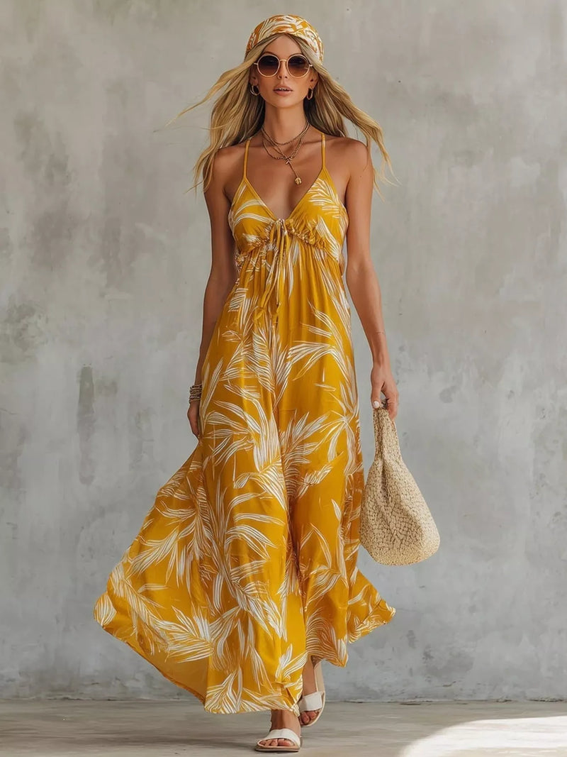 Woman wearing a yellow floral dress against a gray concrete wall.