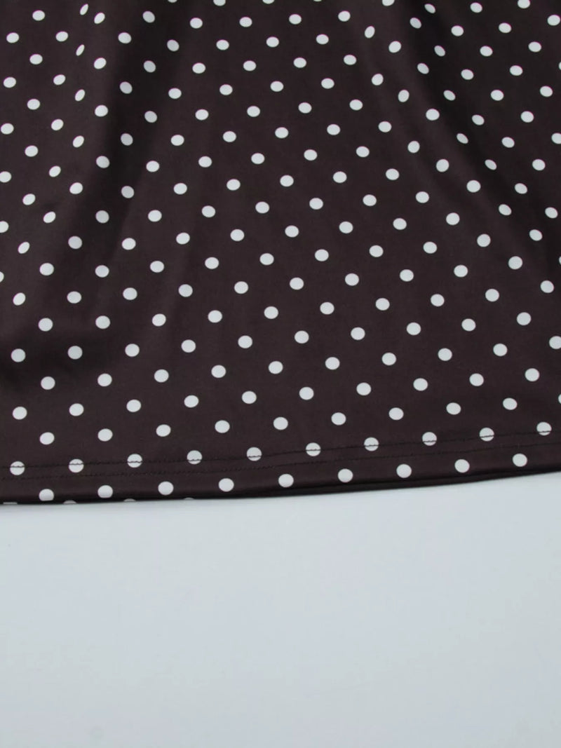 Close-up of a brown fabric with white polka dots on a light gray background