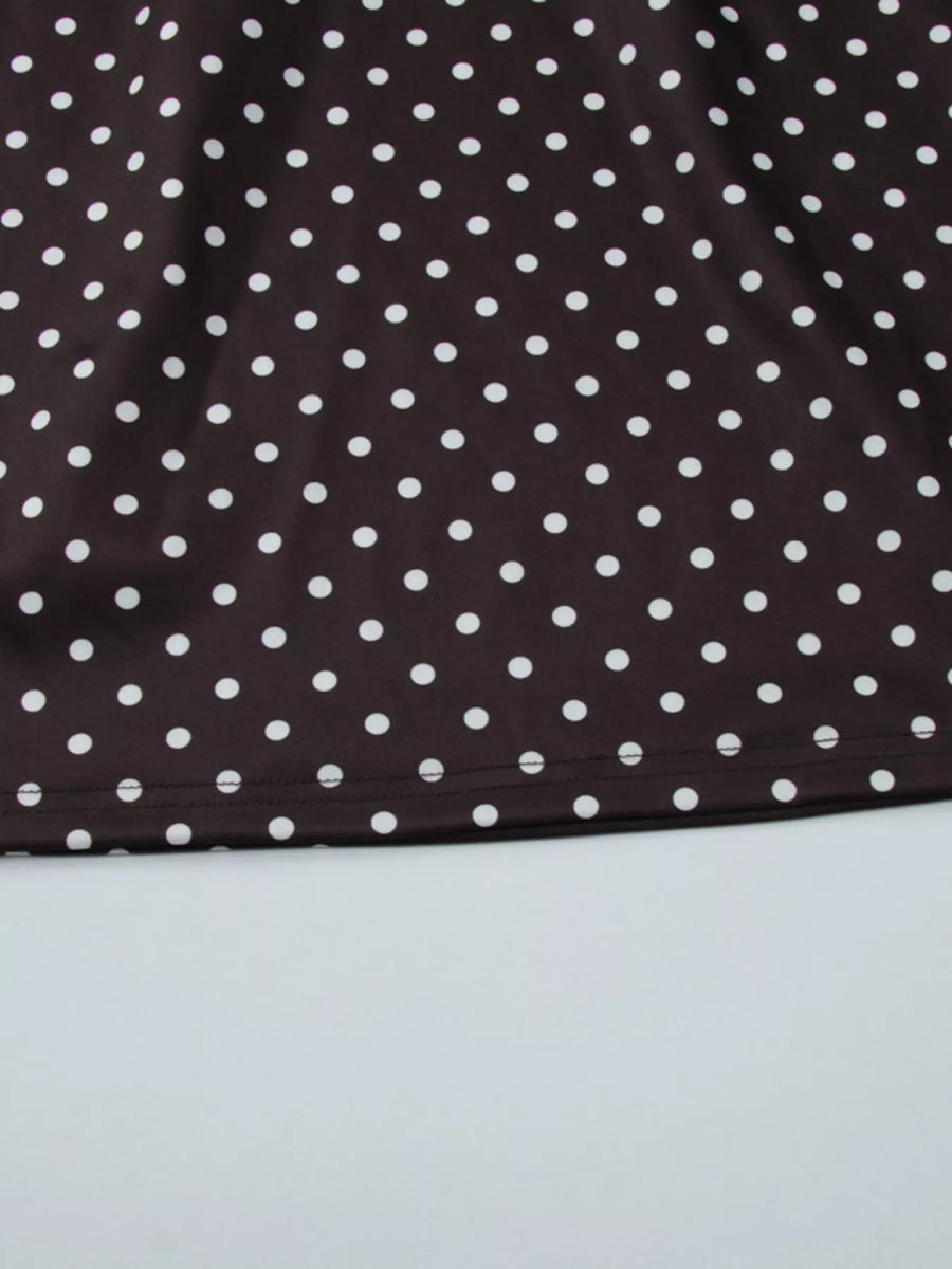 Close-up of a brown fabric with white polka dots on a light gray background
