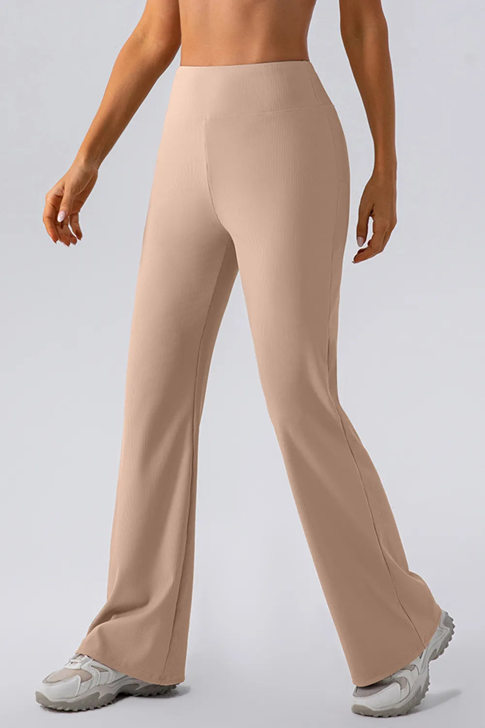 Beige pants worn by a person on a plain background