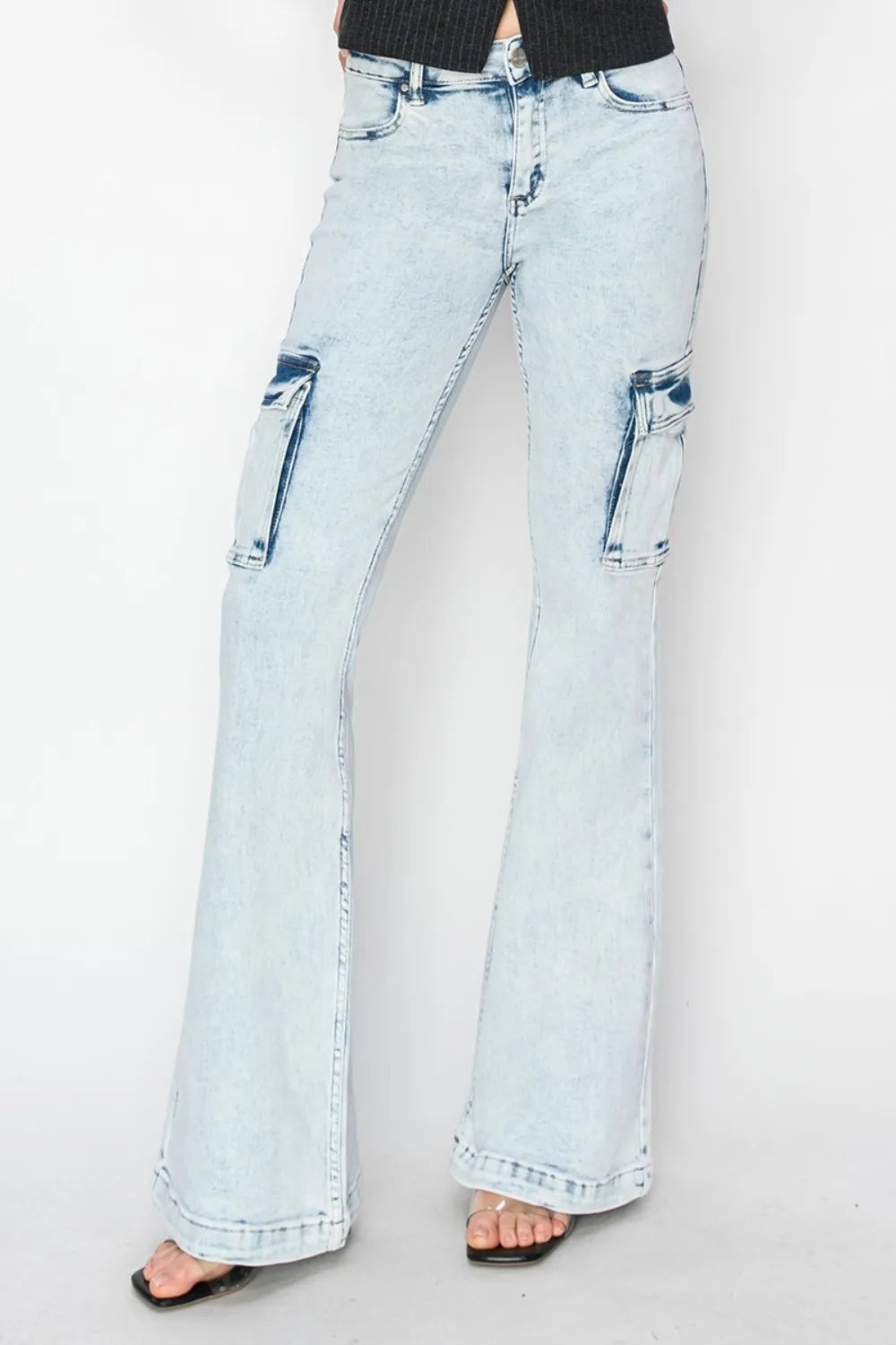 Light blue flared jeans on a plain background