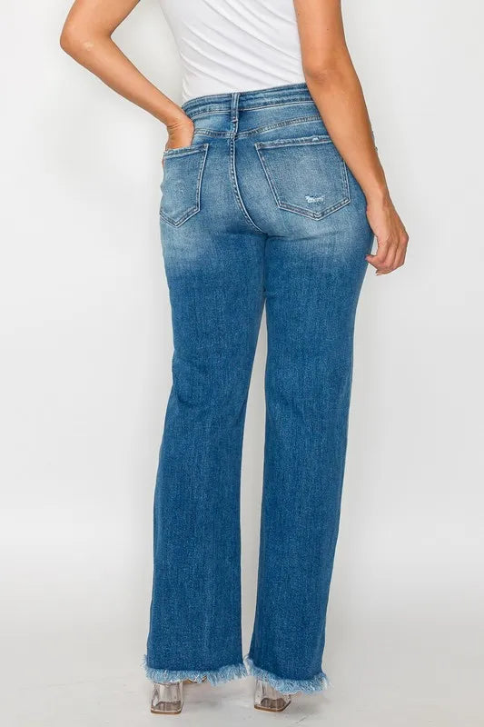 Blue jeans worn by a person on a white background