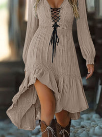Beige lace-up dress worn by a person with a blurred background